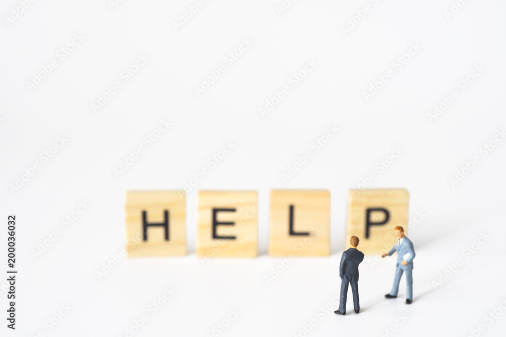 Businessmen talking with help word on wood. Businessmen talking with help word on wood.