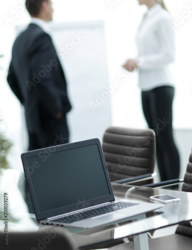 open laptop on the desktop, in the conference room
