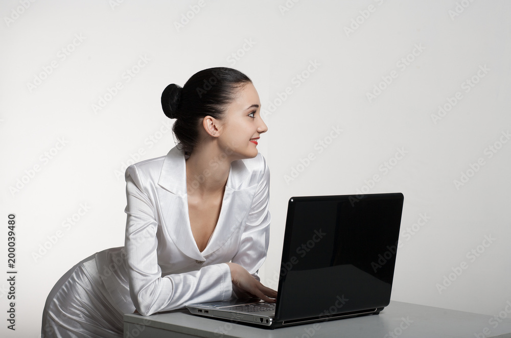 Young beautiful girl - manager with glasses, with laptop