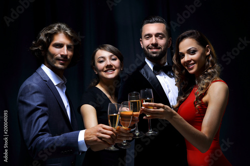 Cheerful people celebrating a sucess with Champagne