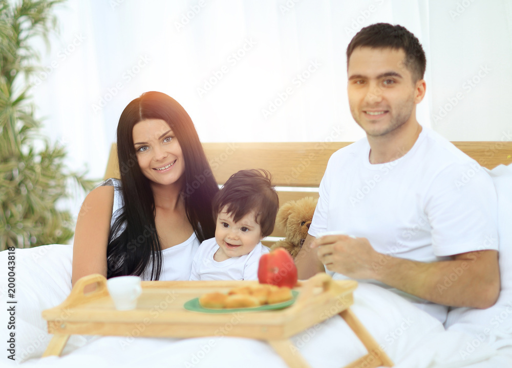 Family having breakfast in bed at home