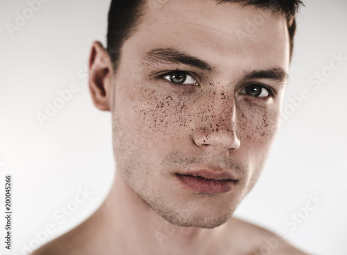 Quadro em tela Close up dirty face of serious nude man watching at camera