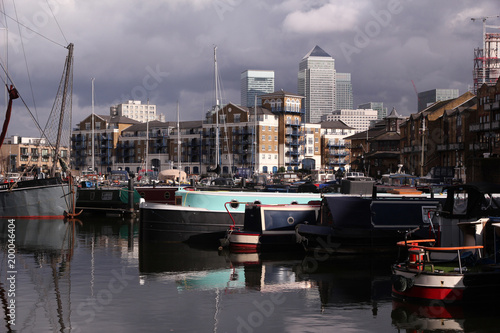 The famous towers and skyscrapers of Docklands rise above the marina and docks showing beautiful reflections in Limeshouse basin