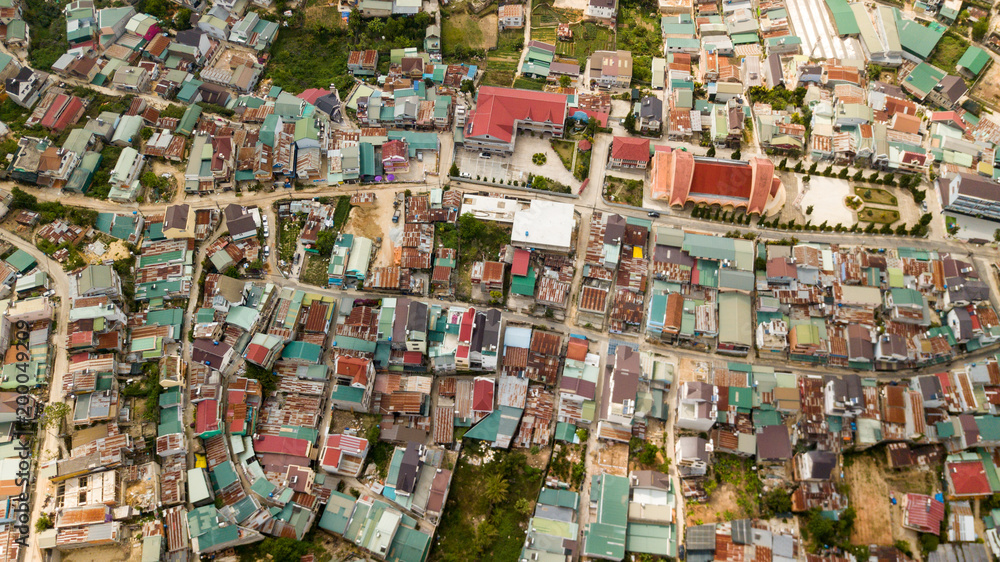 Aerial view from the drone to Dalat city roofs and roads.Located on the Langbian Plateau in the southern parts of the Central Highlands region of Vietnam Aerial view from the drone to Dalat city roofs and roads.Located on the Langbian Plateau in the southern parts of the Central Highlands region of Vietnam