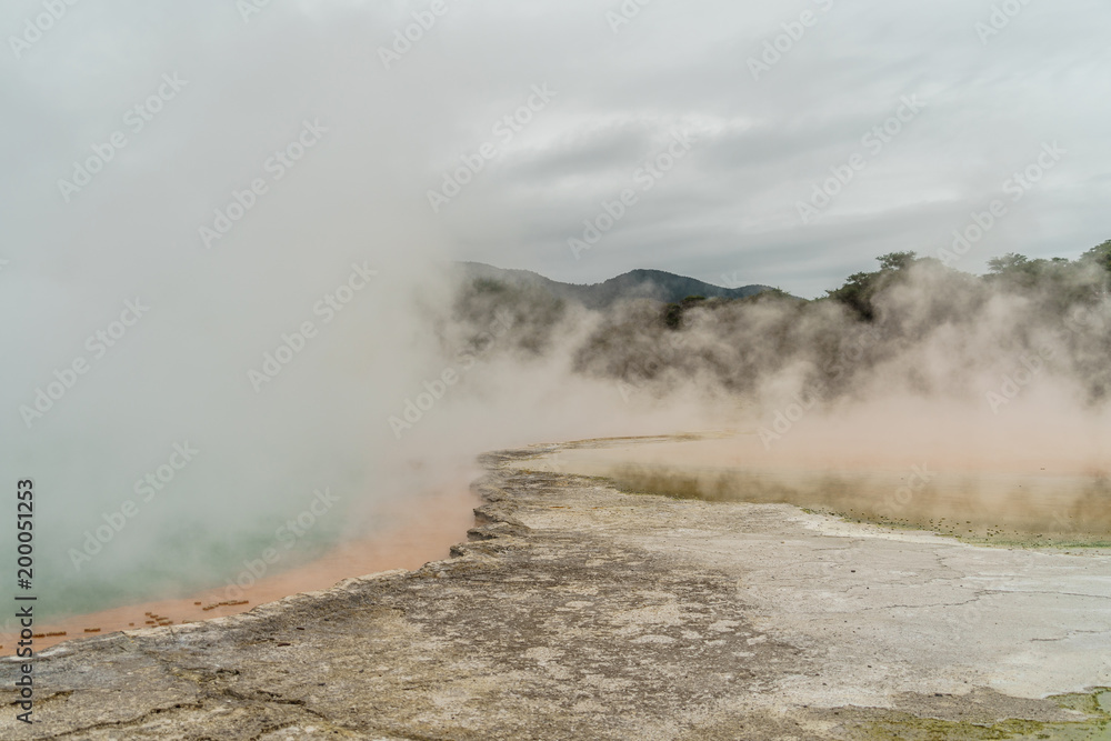 dramatic shot of steaming hot spring on cloudy day, New Zealand