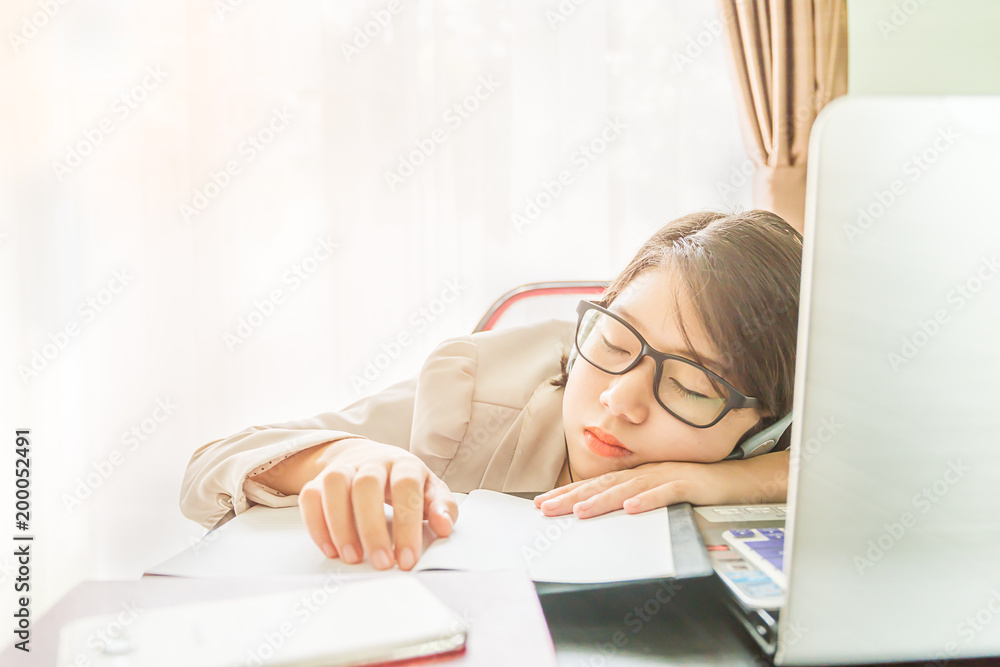 Teenage girl short hair sleep on desk after working Teenage girl short hair sleep on desk after working