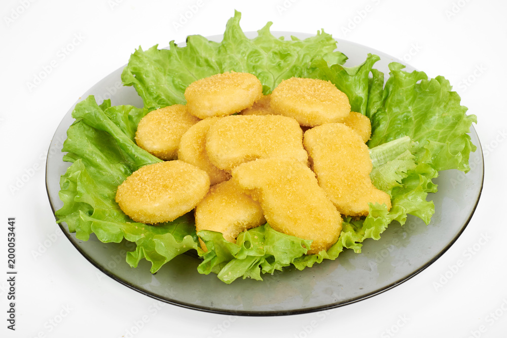 chicken nuggets and vegetables on a white plate, isolated on white chicken nuggets and vegetables on a white plate, isolated on white