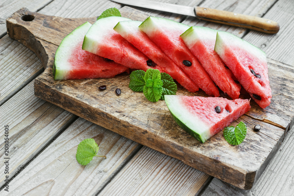 Fresh sliced watermelon in a metal bowl wooden background Fresh sliced watermelon in a metal bowl wooden background