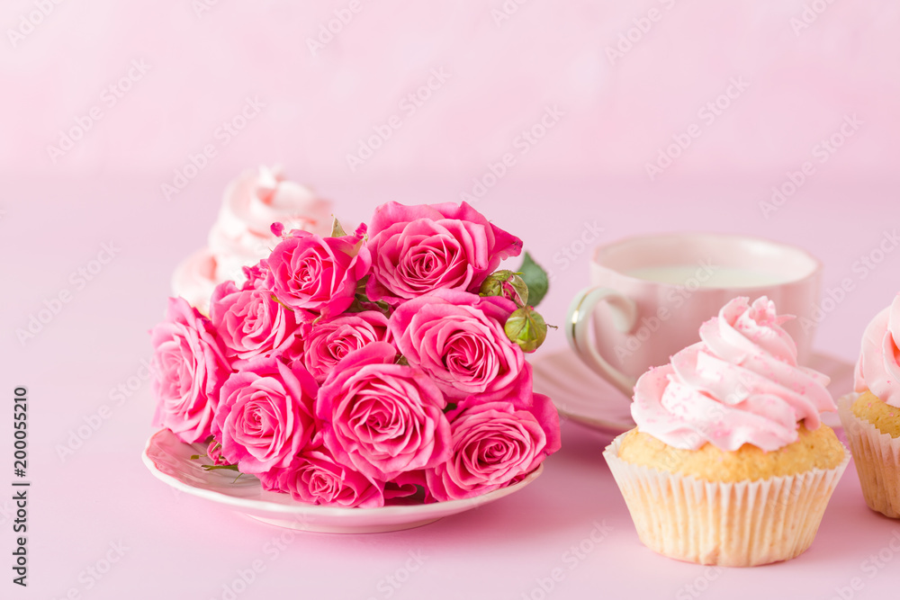 Cupcake with pink cream decoration and roses on pink pastel background. Cupcake with pink cream decoration and roses on pink pastel background.