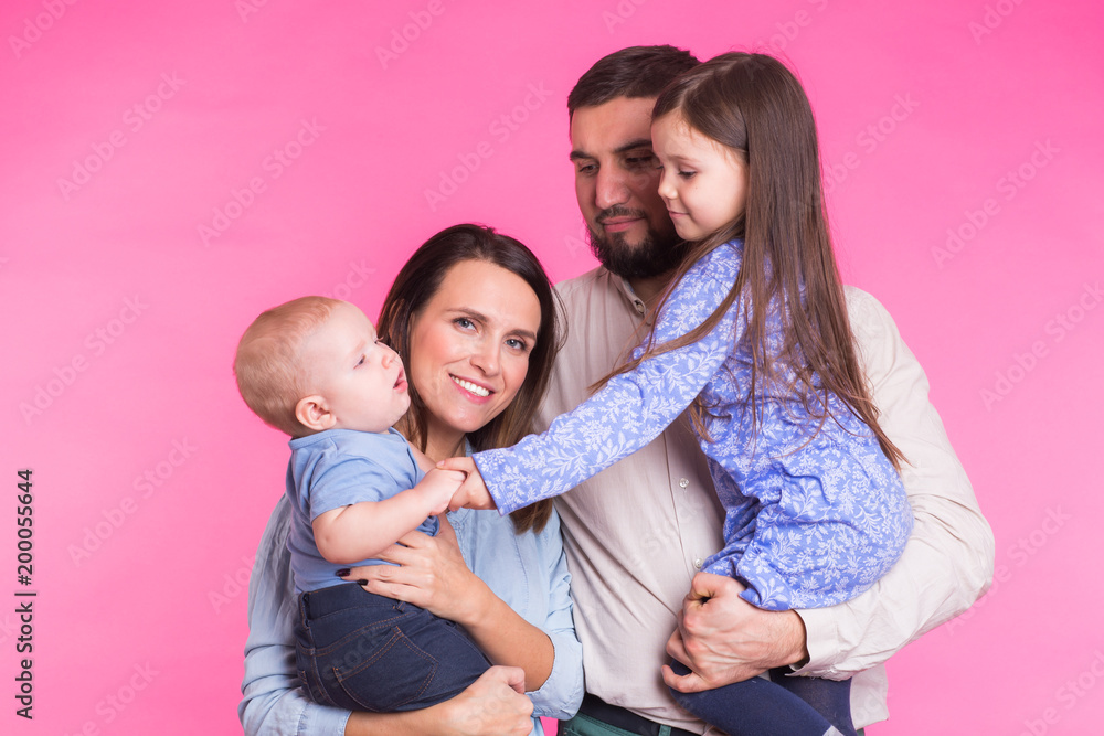 Portrait of Young Happy Mixed Race Family over pink background Portrait of Young Happy Mixed Race Family over pink background