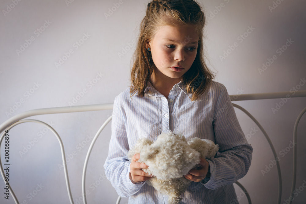 Cute girl holding teddy bear
