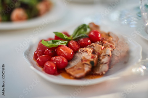 meat with cherry tomatoes and basil