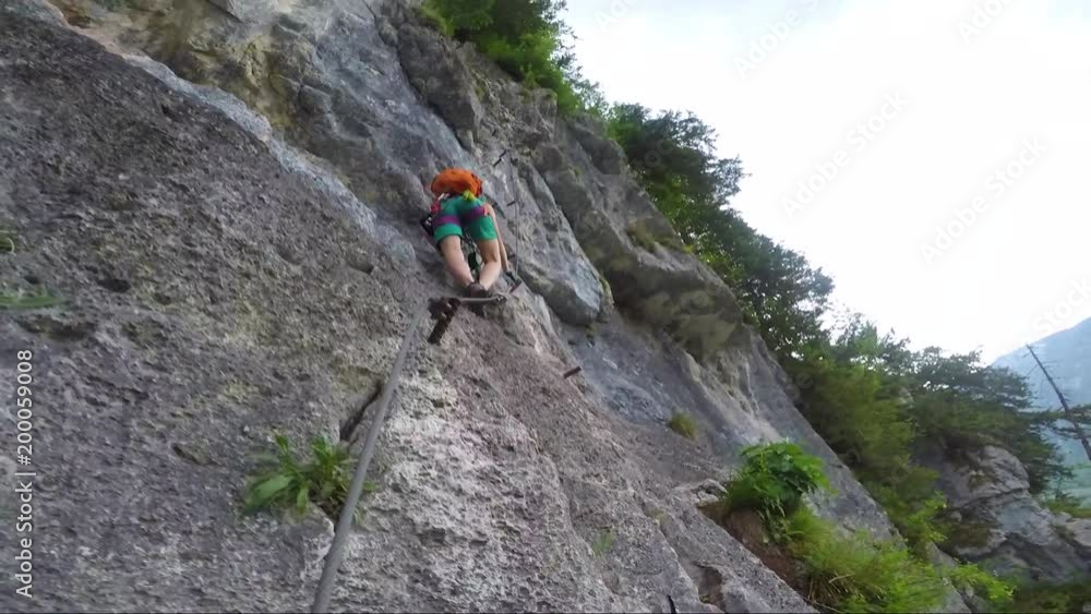 POV - a man climbs up a cliff in a forest POV - a man climbs up a cliff in a forest