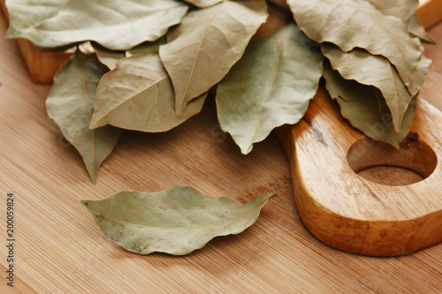 dry bay leaf on a wooden kitchen cutting board