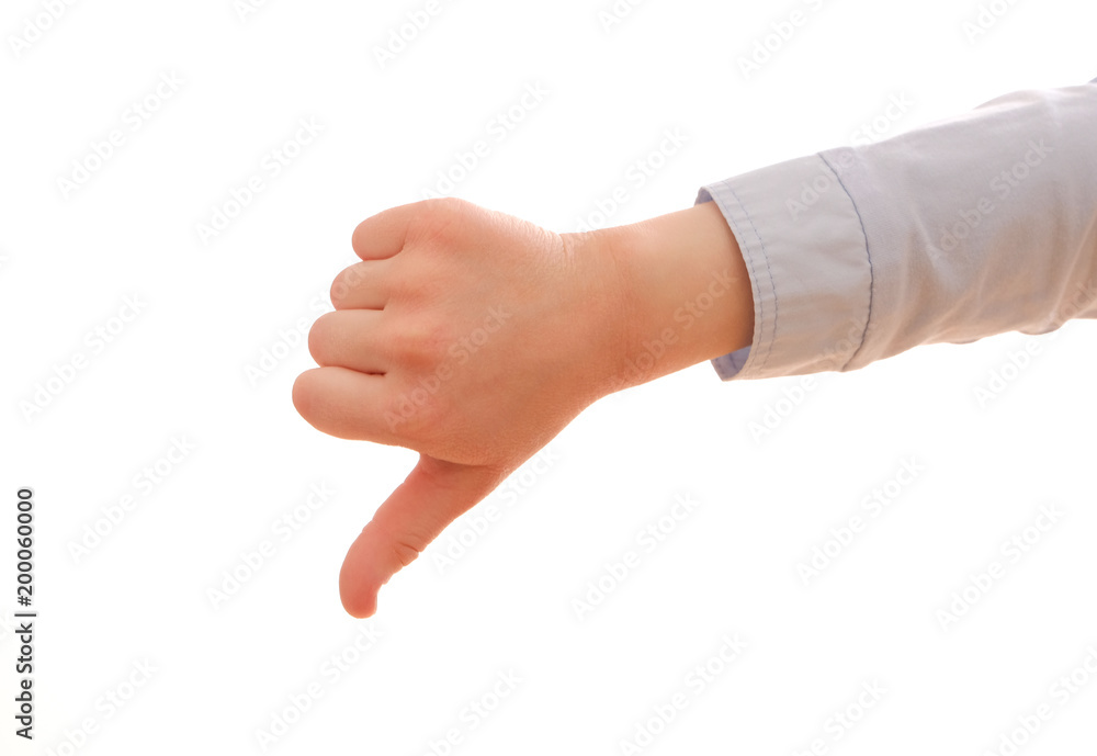 A child's hand showing a gesture of thumb down, isolated on white