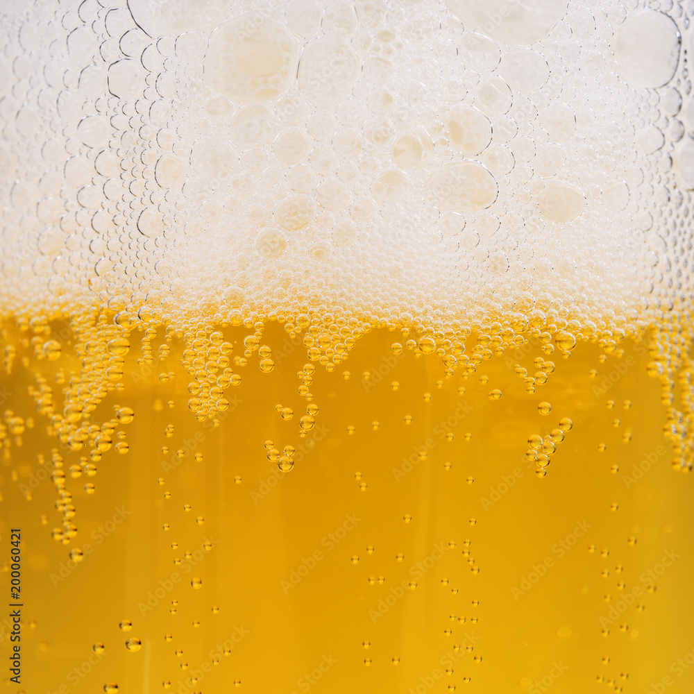 Close up of beer bubbles with froth, beer background Close up of beer bubbles with froth, beer background