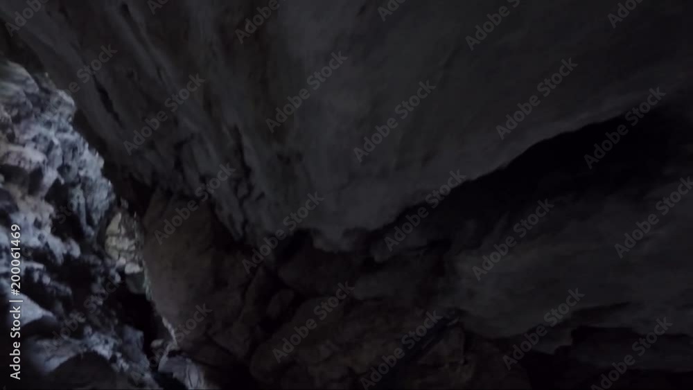 POV - a rock climber rearranges the carabiners at a rock wall in a chasm POV - a rock climber rearranges the carabiners at a rock wall in a chasm