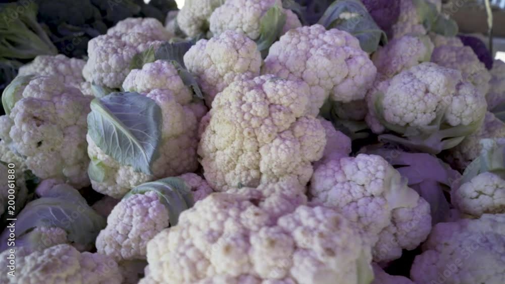 Closeup motion of cauliflower and broccoli at an outdoor farmers market. Closeup motion of cauliflower and broccoli at an outdoor farmers market.