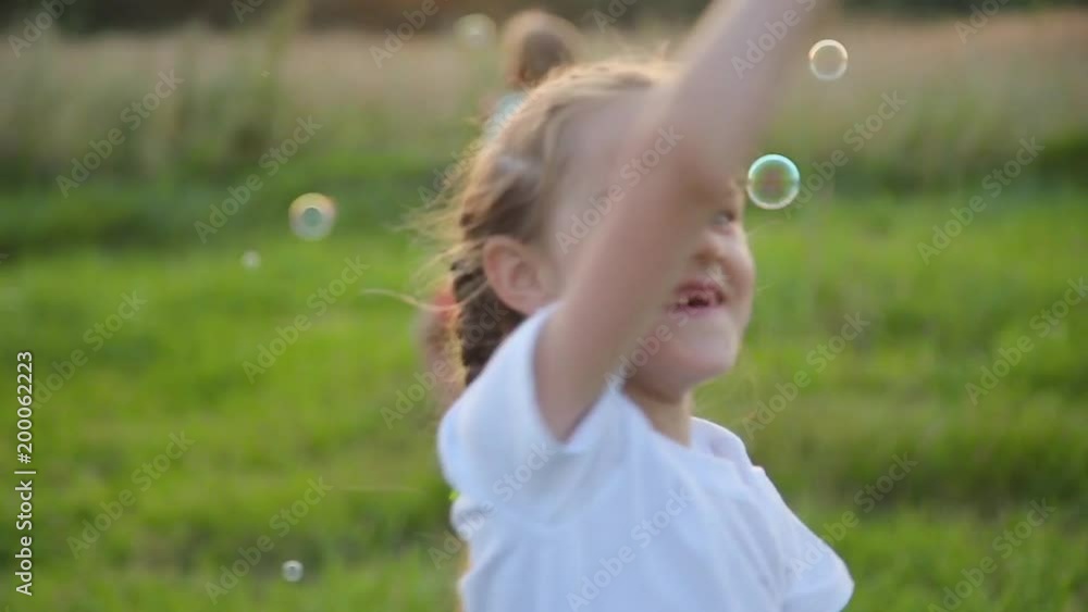 happy kids playing with soap bubbles happy kids playing with soap bubbles