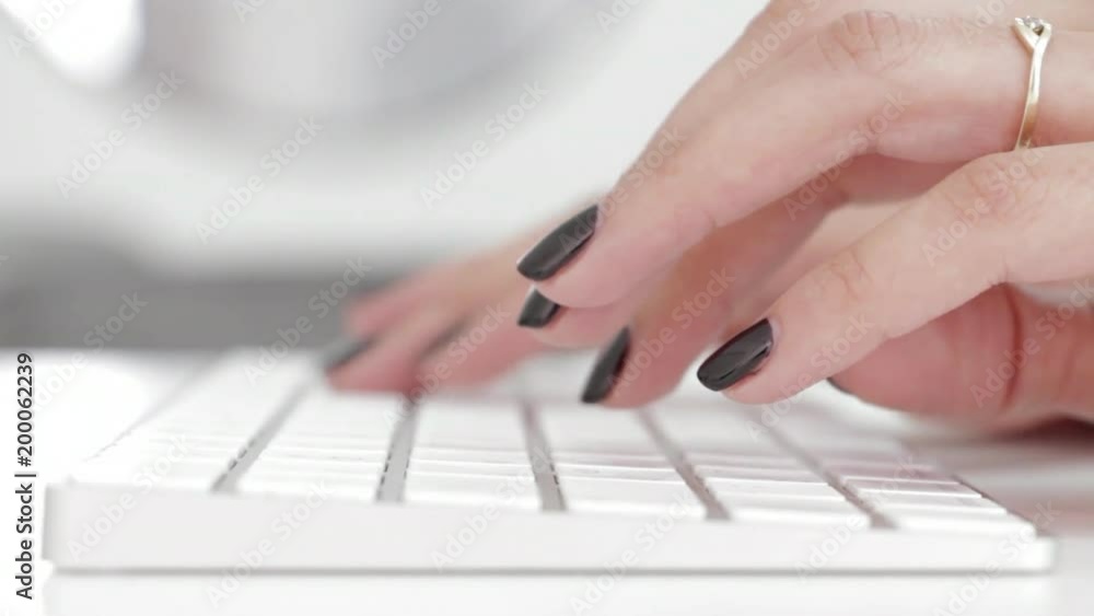 Female hands typing on computer keyboard Female hands typing on computer keyboard