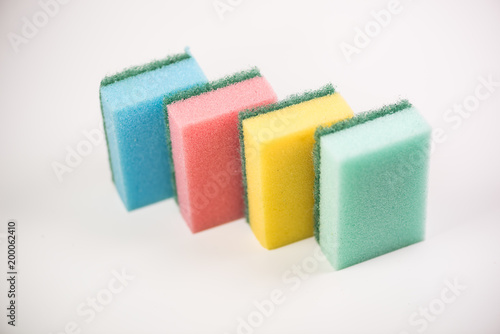 Couple of colorful kitchen cleaning equipment over white background