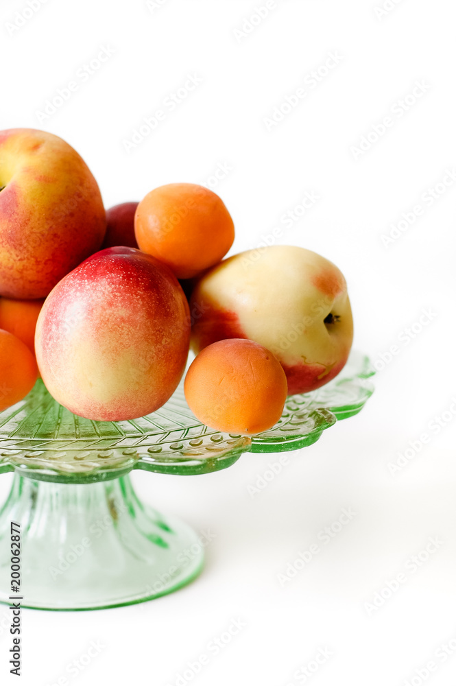 Glass plate with peaches, apricots and nectarines Glass plate with peaches, apricots and nectarines