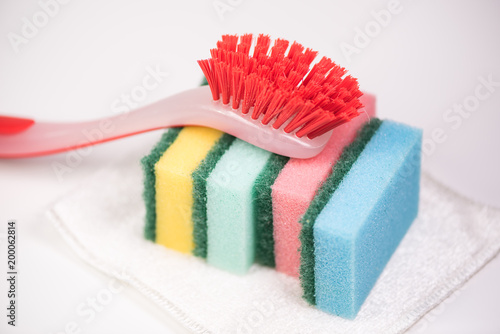 Couple of colorful kitchen cleaning equipment over white background