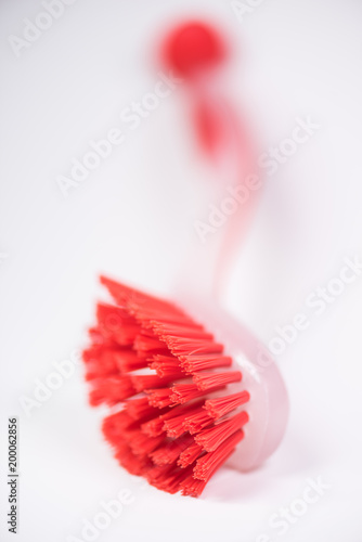 Couple of colorful kitchen cleaning equipment over white background