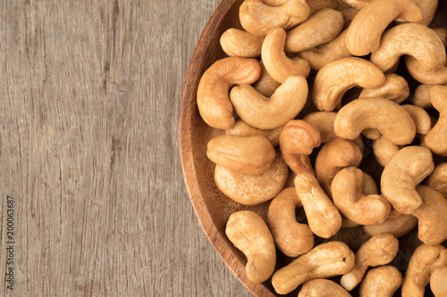 Cashew nuts in wooden bowl  on woden table.