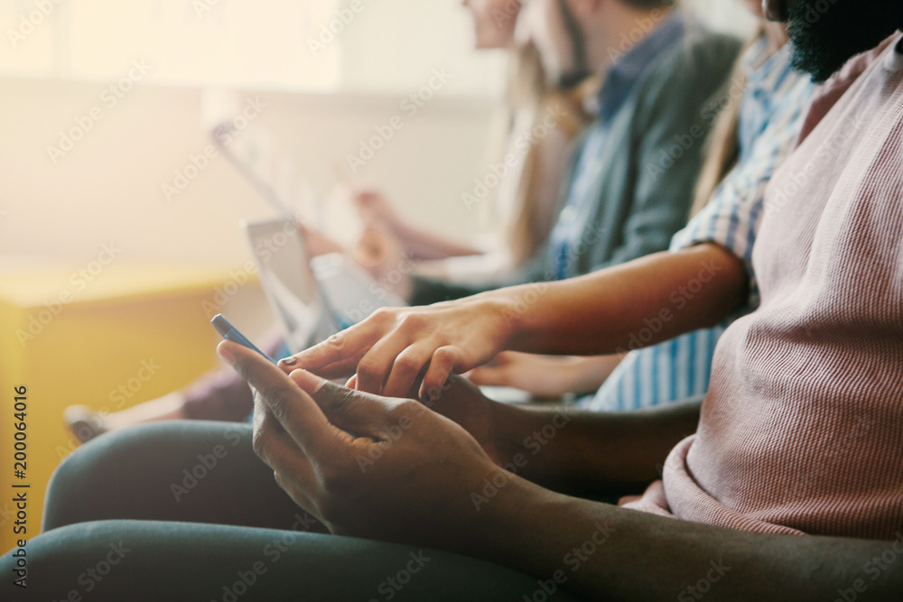 Close up on the hand of a young handsome afro black man using a smartphone, tapping the screen - technology, social network, communication concept. Close up on the hand of a young handsome afro black man using a smartphone, tapping the screen - technology, social network, communication concept.