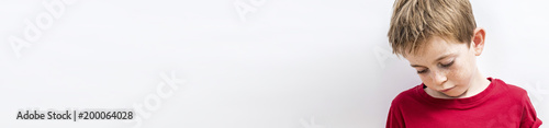 upset child looking down expressing disappointment, disillusion or sadness, banner