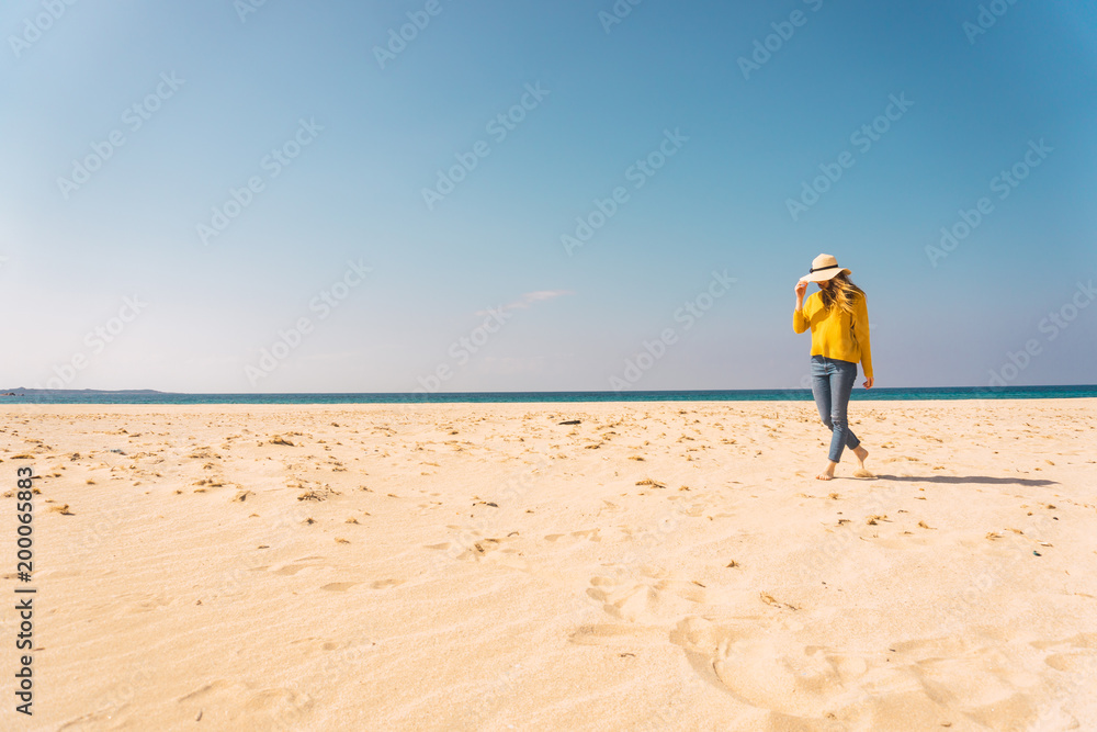 Woman standing on sandy shore Woman standing on sandy shore