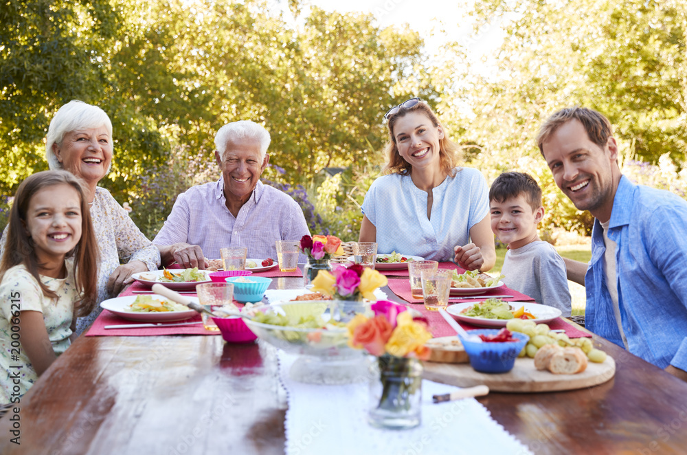 Three generation family having lunch in the garden Three generation family having lunch in the garden