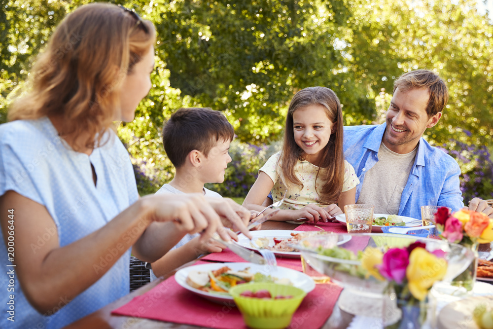 Parents and kids having a lunch together in the garden