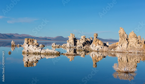 Sunset at Mono lake, California. Bizarre calcareous tufa formation on the smooth water of the lake.