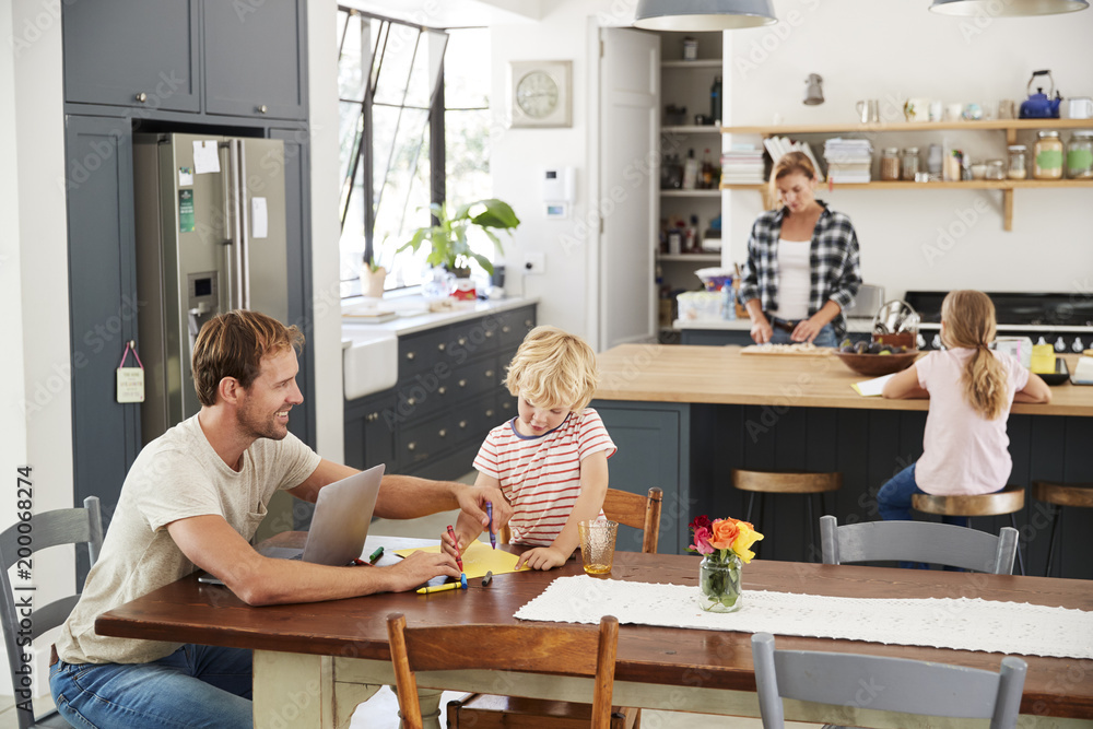 Young white family busy in their kitchen, elevated view Young white family busy in their kitchen, elevated view