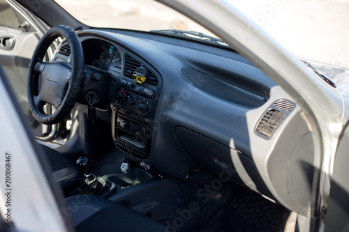 Interior of a modern luxury car. Steering wheel © Shkriabii