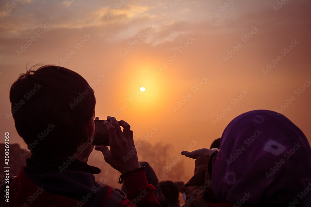 sweet couple take a photo togetter during waitting sunrise upon the Mountain