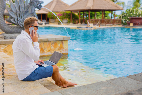 Businessman working while on vacation photo