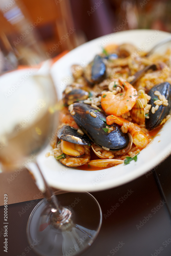 a plate of rice with shrimps and mussels