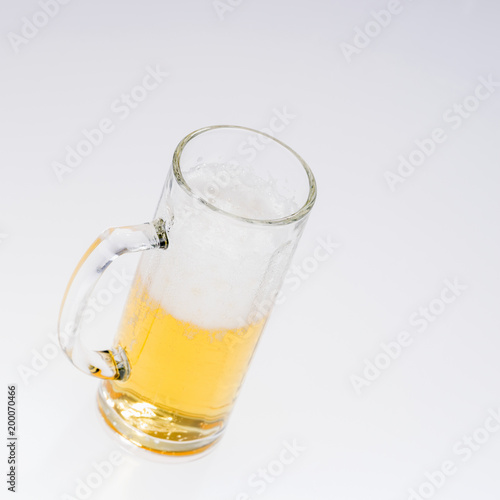 Big glass of beer isolated on a light background