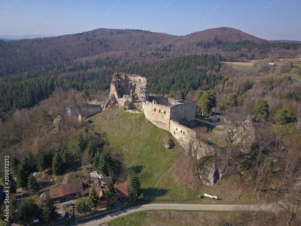 Kamenets, near Odjykon, Poland -april 8, 2018: Ancient ruins of a medieval castle against the backdrop of a natural landscape of the central strip of central Europe. View of drone. Panorama of fly.