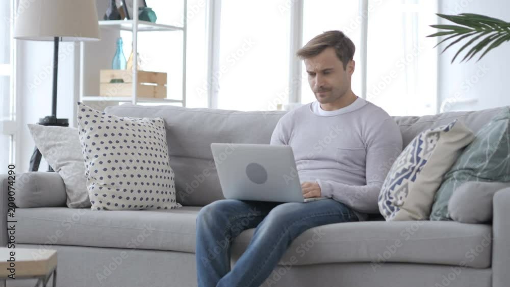 Cough, Man Coughing while Working on Laptop in Couch Cough, Man Coughing while Working on Laptop in Couch