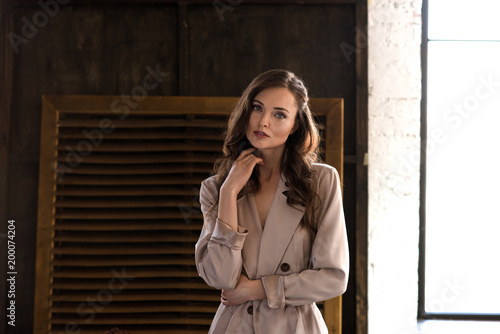 elegant woman in classic beige trench coat