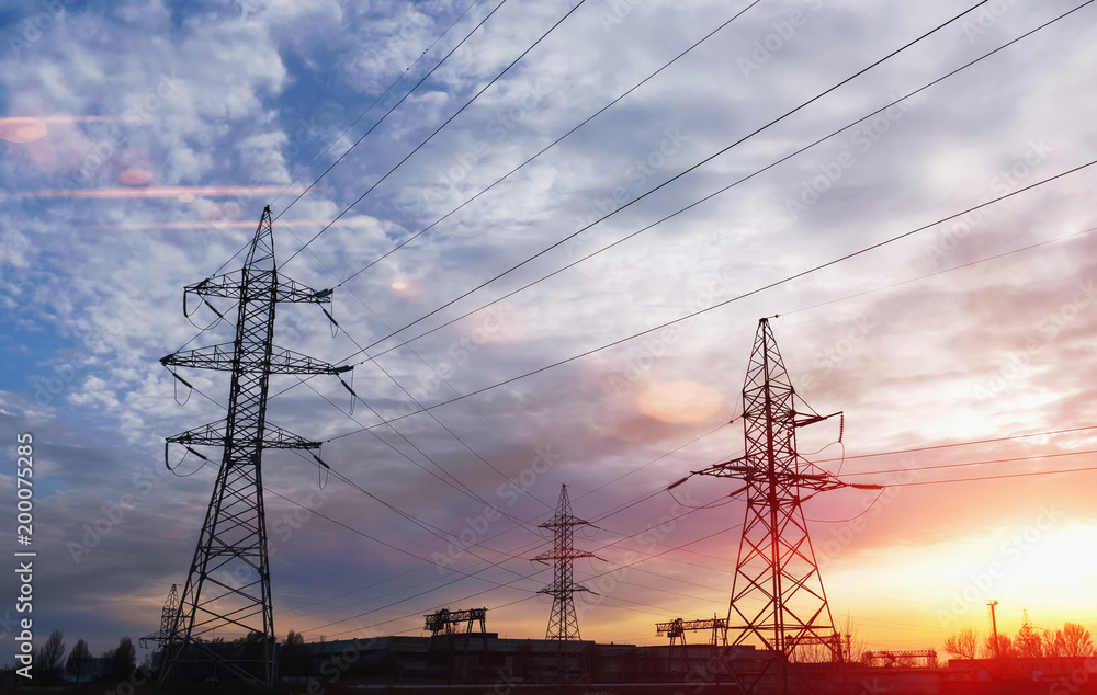 high-voltage power lines at sunset. electricity distribution station. high voltage electric transmission tower