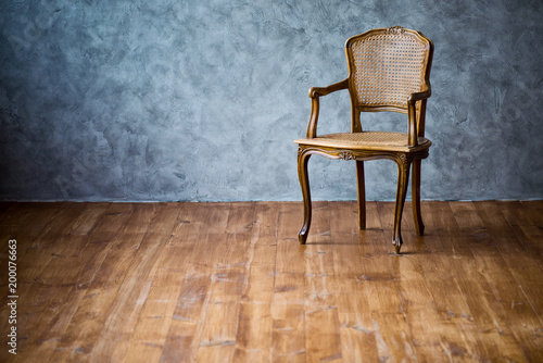 old chair on a gray wall background.