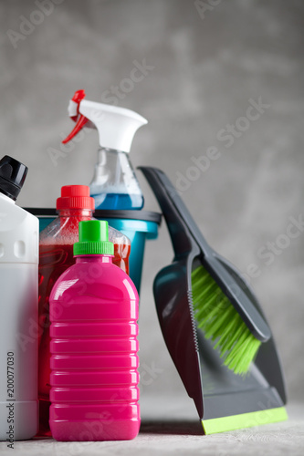 Cleaning supplies on grey background