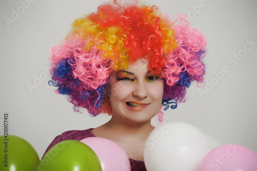 girl in clown wig with balloons