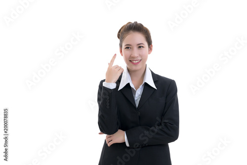 Smiling young Asian businesswoman in black suit and white shirt pointing finger isolated on white background