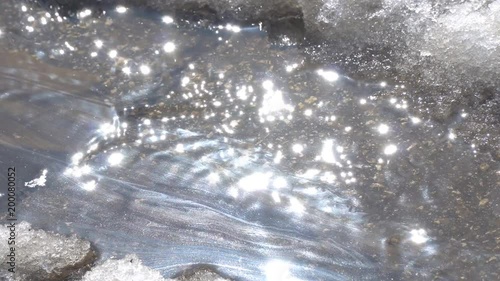 The spring creek is polluted with gasoline on the surface. Oil pollution. Looring photo